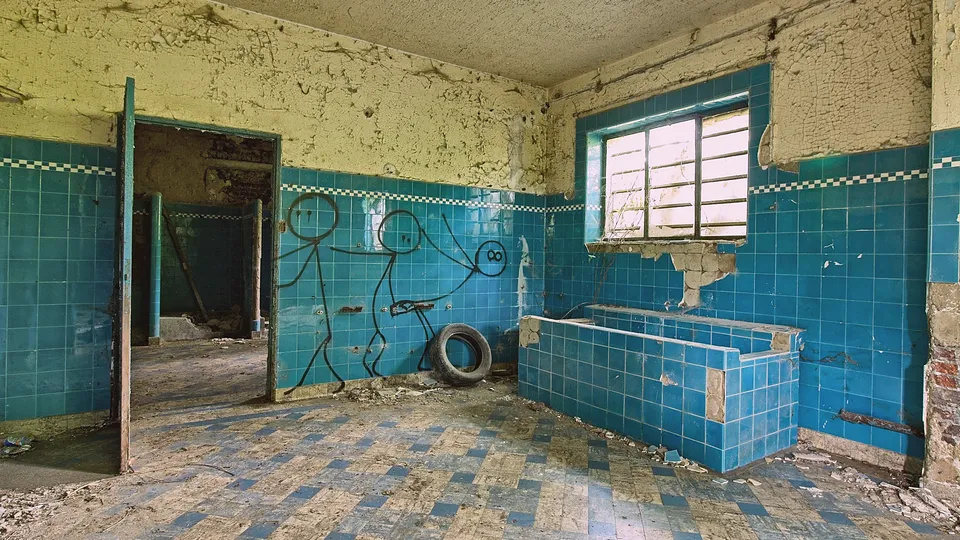 Older bathroom with turquoise wall tile and a built-in tub