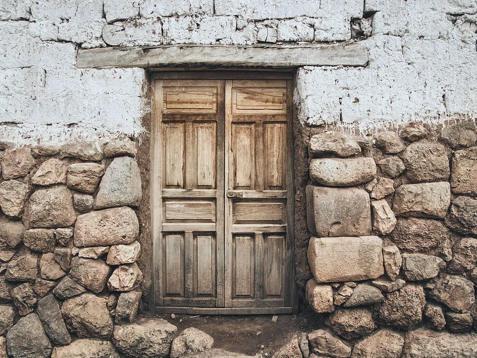 Wooden plank door set in a thick stone wall
