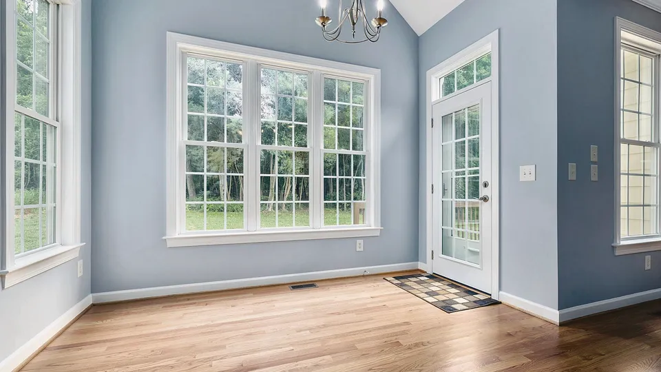 Room with crisp white window and door trim