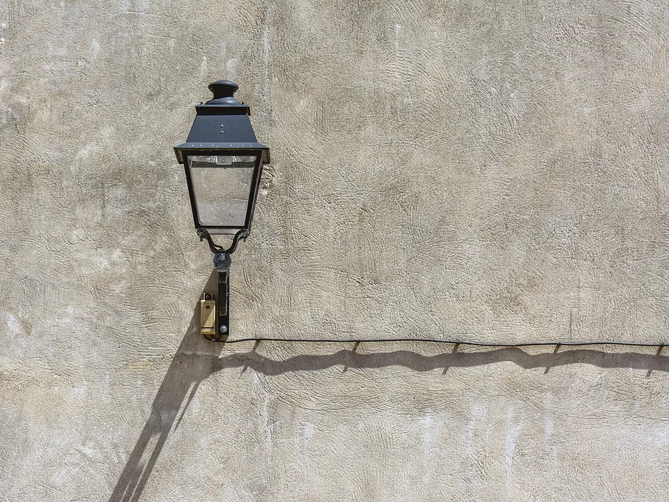 Black lantern fixture on a stucco wall