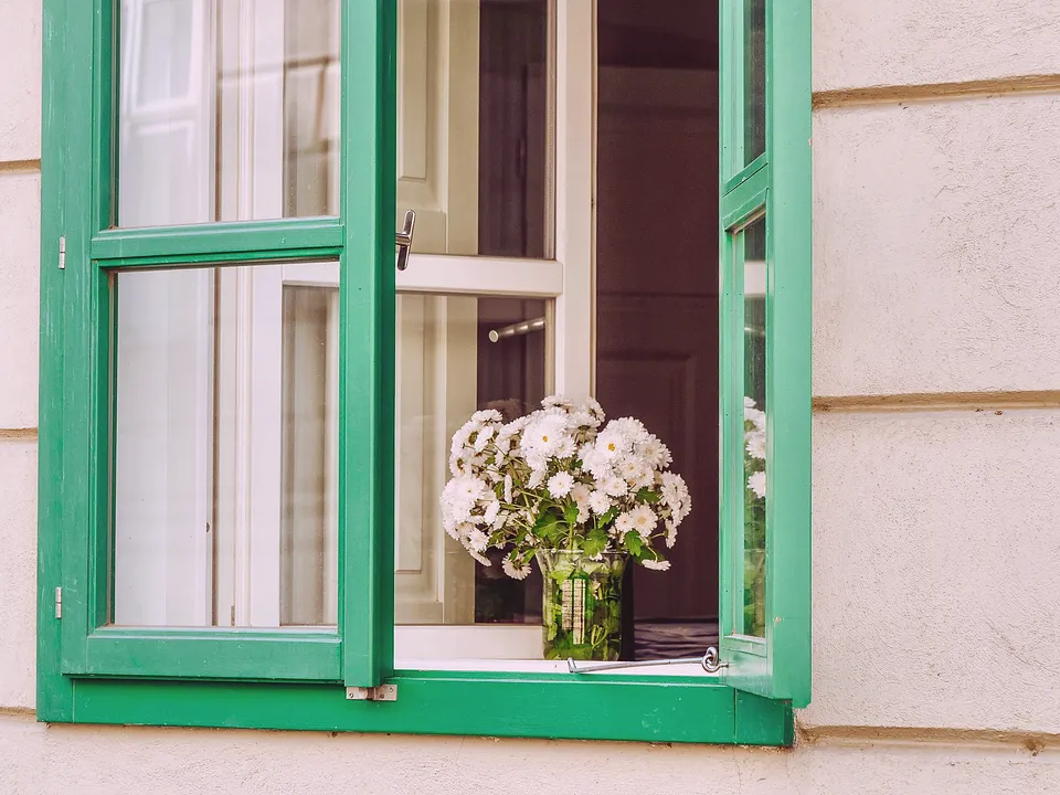 Window with a deep sill and green wood frame