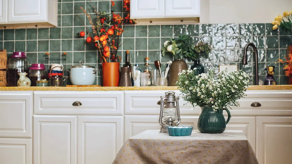 Older kitchen with painted cabinets and a green tile backsplash