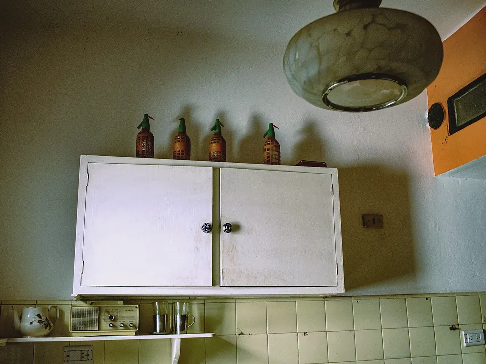 Small painted wall cabinet in an older kitchen