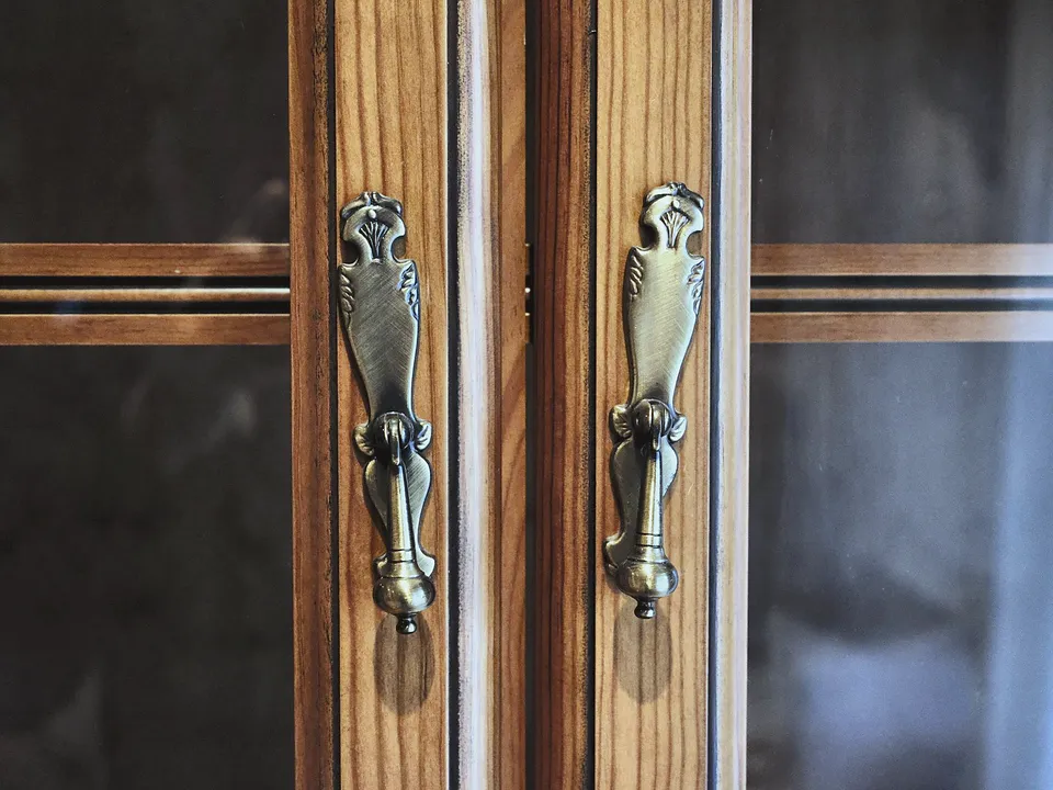 Brass pulls on dark wood cabinet doors