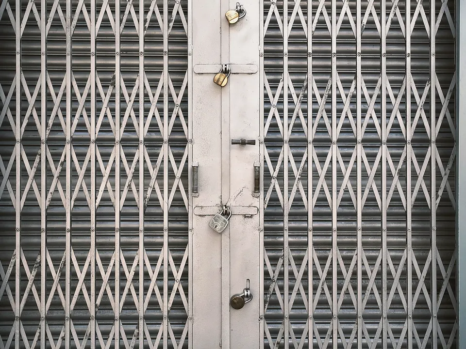 Folding metal security gate in a doorway