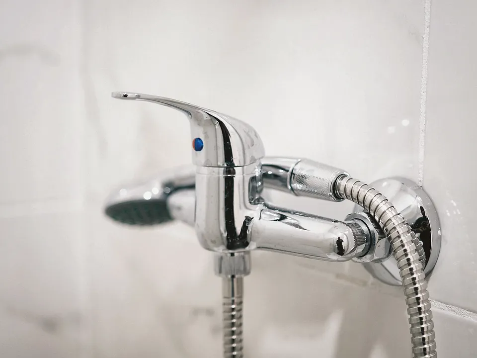Handheld shower head on a chrome tub faucet