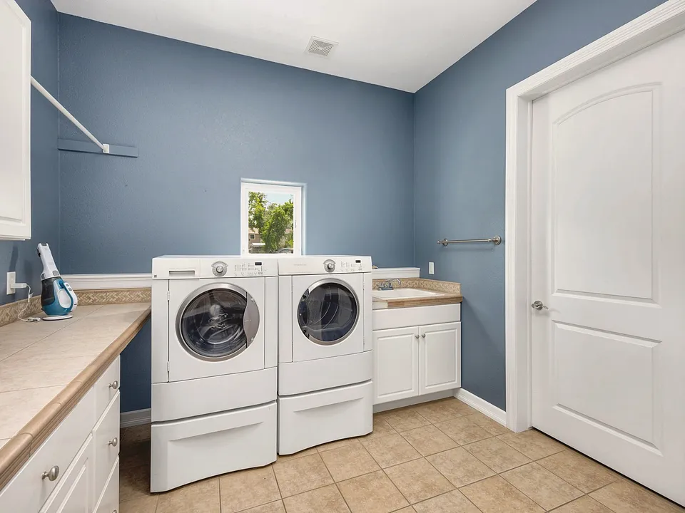 Laundry room with a front-load washer and dryer and a utility sink