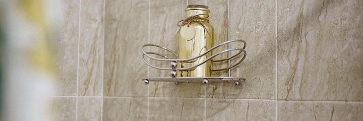 New brushed-nickel single-handle faucet running over a white sink
