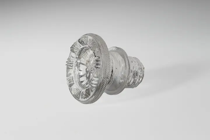 Clear glass cabinet knob on a white background