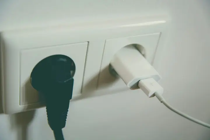 Two plugs in a white double wall outlet