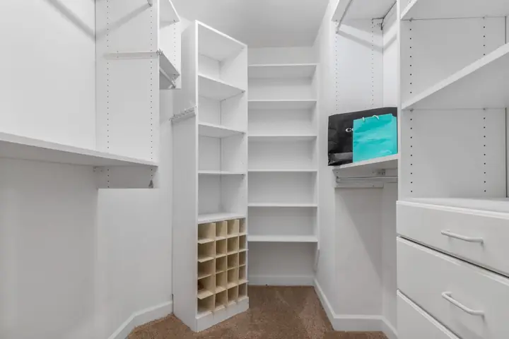 White closet system with shelves, cubbies and drawers