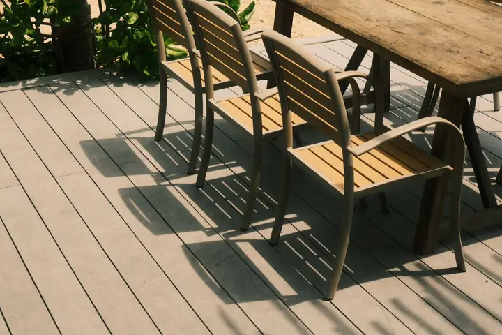 Outdoor patio chairs and table set on a sunny deck