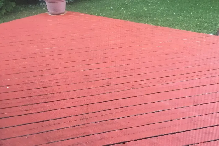 Backyard deck freshly coated in red stain