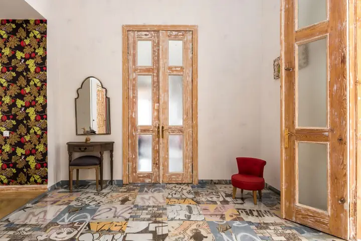 Vintage room with distressed wooden doors and graphic patterned floor