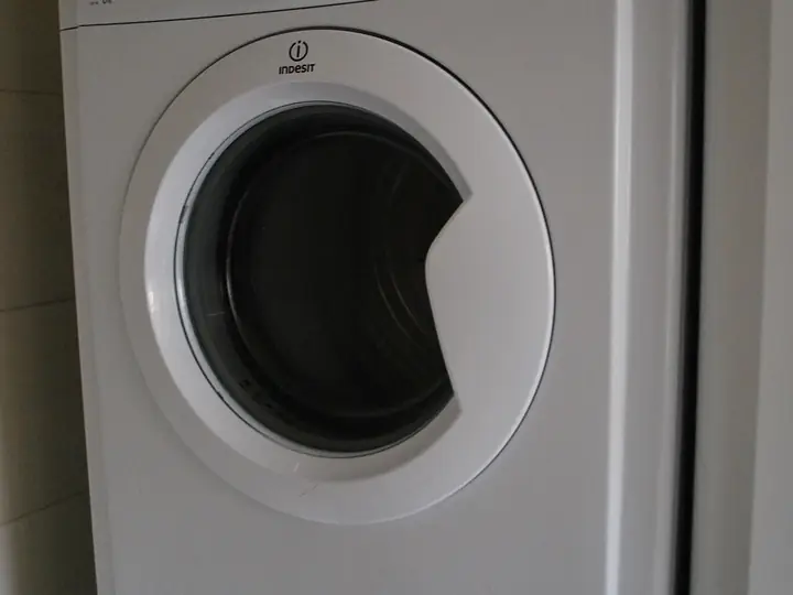 Close view of a white front-load dryer door