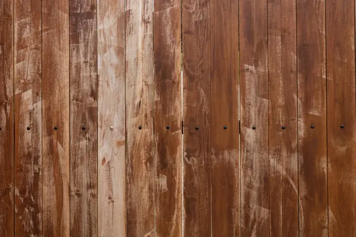 Close view of reddish brown weathered fence boards