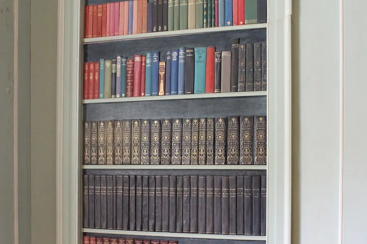 Tall built-in bookcase in a white wall