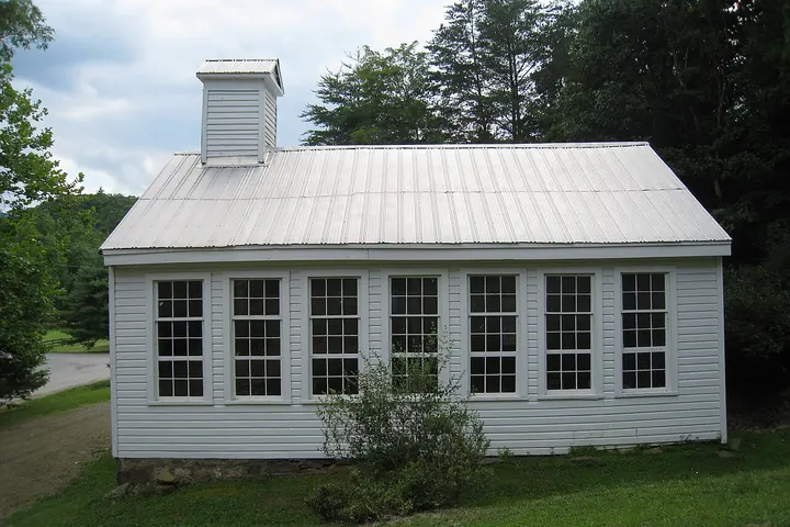 Row of four double-hung sash windows in a plain wall