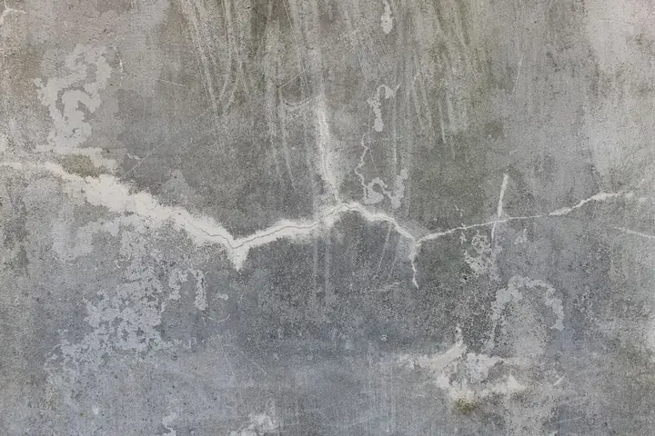 High-resolution image of a weathered and cracked concrete wall