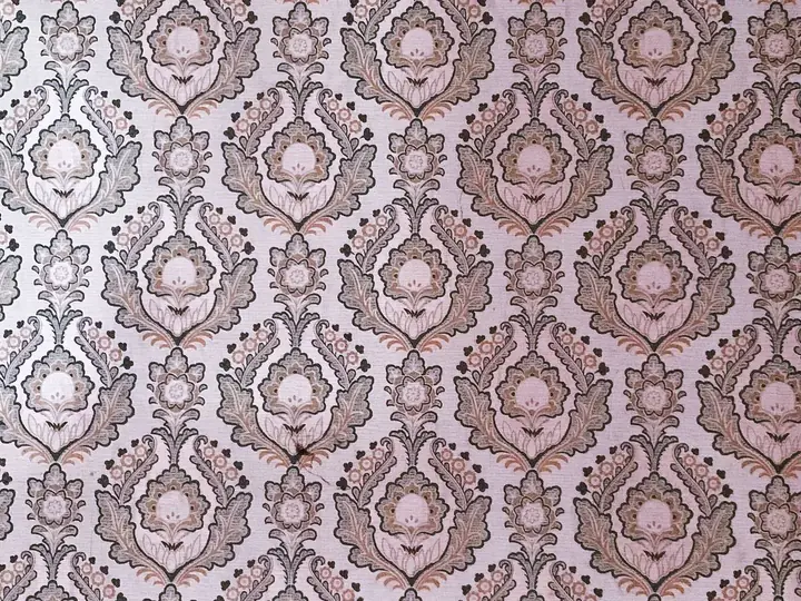 Close view of pink and gray damask pattern wallpaper