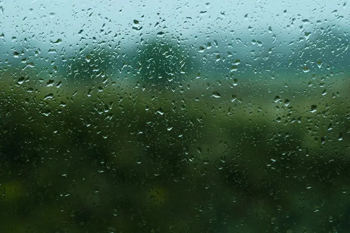 Captivating view through raindrop-covered window in Belfast, evoking a peaceful mood